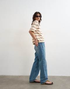 Model wearing Knitted half sleeve t-shirt in neutral stripe