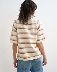Model wearing Knitted half sleeve t-shirt in neutral stripe