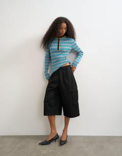 Model wearing Knitted henley long sleeve stripe top in blue multi