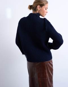 Model wearing Knitted high neck fringe jumper in navy