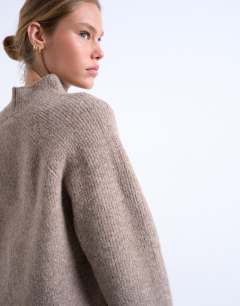 Model wearing Knitted high neck jumper in espresso