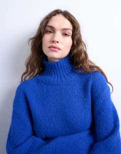 Model wearing Knitted high neck longline jumper with neck detail