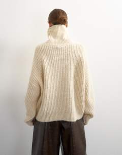 Model wearing Knitted high neck ribbed jumper lace detail in ivory