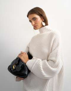 Model wearing Knitted high neck roll seam detail oversized jumper with wool in ivory