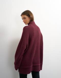 Model wearing Knitted high neck roll seam detail oversized jumper with wool in mulberry