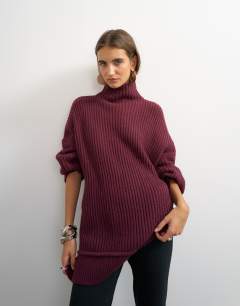 Model wearing Knitted high neck roll seam detail oversized jumper with wool in mulberry