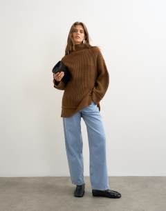Model wearing Knitted high neck roll seam detail oversized jumper with wool in pecan