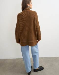 Model wearing Knitted high neck roll seam detail oversized jumper with wool in pecan