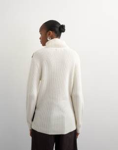 Model wearing Knitted high roll neck wool blend intarsia chevron jumper in ivory