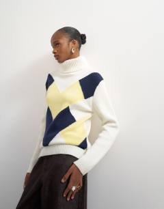 Model wearing Knitted high roll neck wool blend intarsia chevron jumper in ivory