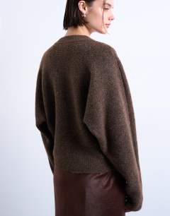 Model wearing Knitted high v horizontal stitch jumper in brown
