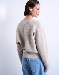 Model wearing Knitted high v horizontal stitch jumper in oat