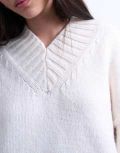 Model wearing Knitted high V-neck mini oversized dress in ivory