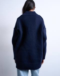 Model wearing Knitted high V-neck mini oversized dress in Navy