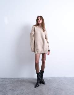 Model wearing Knitted high v-neck mini oversized dress in oat