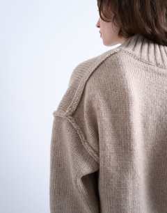 Model wearing Knitted high v-neck mini oversized dress in oat