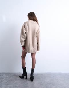 Model wearing Knitted high v-neck mini oversized dress in oat