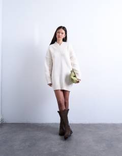 Model wearing Knitted high v-neck mini oversized jumper dress in ivory