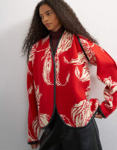 Model wearing Knitted kimono PU trim jacket in red and ivory