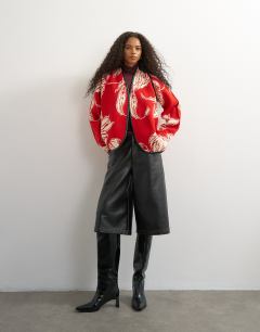 Model wearing Knitted kimono PU trim jacket in red and ivory