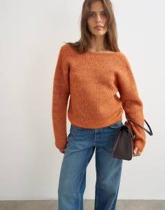 Model wearing Knitted knot back detail jumper with wool in terracotta