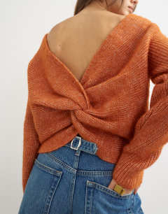 Model wearing Knitted knot back detail jumper with wool in terracotta