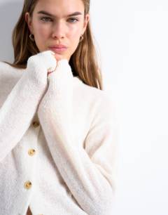 Model wearing Knitted lightweight crew cardigan in oat