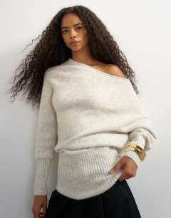 Model wearing Knitted long sleeve fallen shoulder jumper with wool in latte