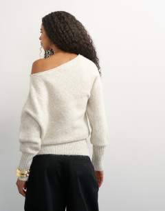 Model wearing Knitted long sleeve fallen shoulder jumper with wool in latte