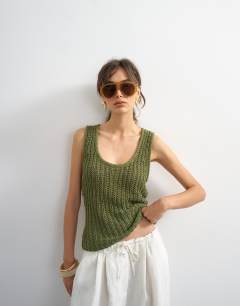Model wearing Knitted low scoop crochet vest top in khaki