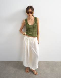 Model wearing Knitted low scoop crochet vest top in khaki