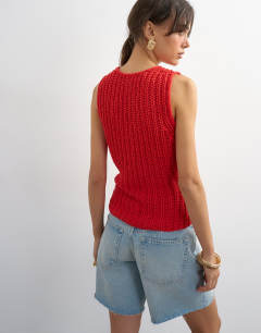 Model wearing Knitted low scoop crochet vest top in red