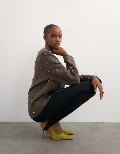 Model wearing Knitted metal studded shoulder pad jumper in brown