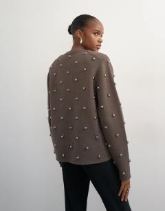 Model wearing Knitted metal studded shoulder pad jumper in brown