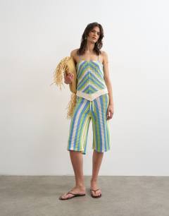 Model wearing Knitted mix stripe co-ord stitchy halter top in green and blue multi