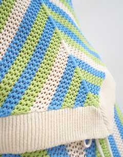 Model wearing Knitted mix stripe co-ord stitchy halter top in green and blue multi