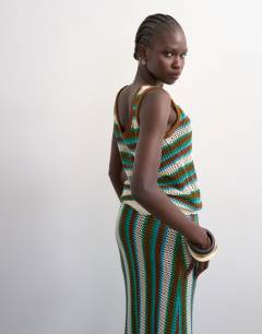 Model wearing Knitted multi stripe co-ord vest in blue and brown