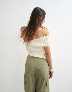 Model wearing Knitted one shoulder asymmetric top in ivory