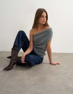 Model wearing Knitted one shoulder draped top in grey