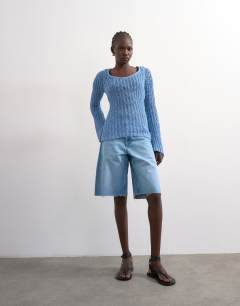 Model wearing Knitted open stitch long sleeved top in blue