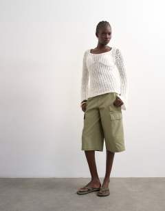 Model wearing Knitted open stitch long sleeved top in ivory