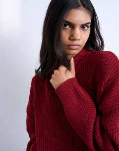 Model wearing Knitted oversized clean wide neck rib jumper in rust