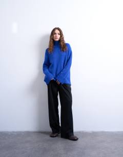 Model wearing Knitted oversized high neck longline jumper with neck detail