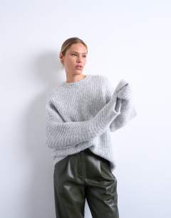 Model wearing Knitted oversized ribbed balloon sleeve jumper in grey