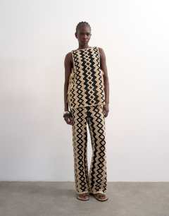 Model wearing Knitted patterned crochet co-ord shirt in black and beige