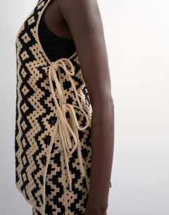 Model wearing Knitted patterned crochet co-ord shirt in black and beige