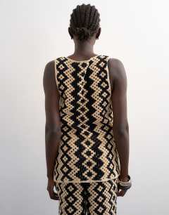 Model wearing Knitted patterned crochet co-ord shirt in black and beige