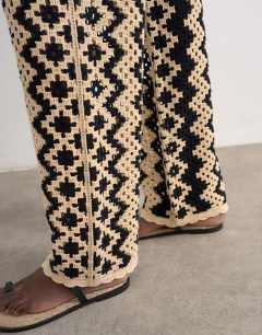 Model wearing Knitted patterned crochet co-ord trouser in black and beige