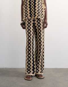 Model wearing Knitted patterned crochet co-ord trouser in black and beige