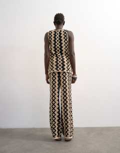Model wearing Knitted patterned crochet co-ord trouser in black and beige